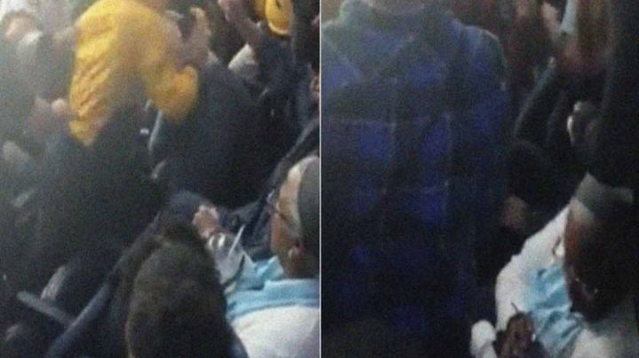 Inmutable: Señora pacífica disfruta su café en una pelea de aficionados de hockey