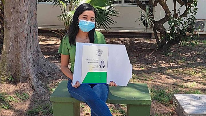 Universitaria posa con su título en la banquita donde vendía dulces para pagar su carrera