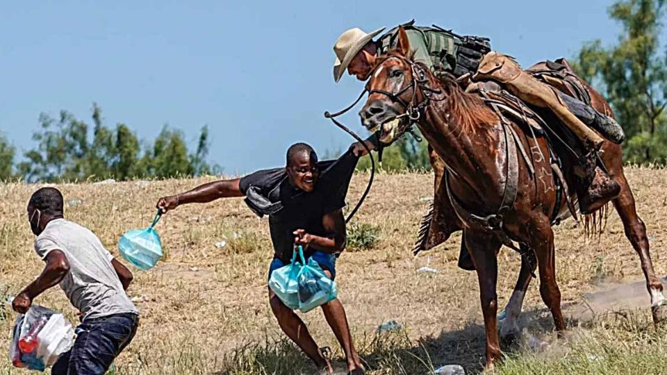 Un agente de la Border Patrol inmoviliza a un inmigrante haitiano