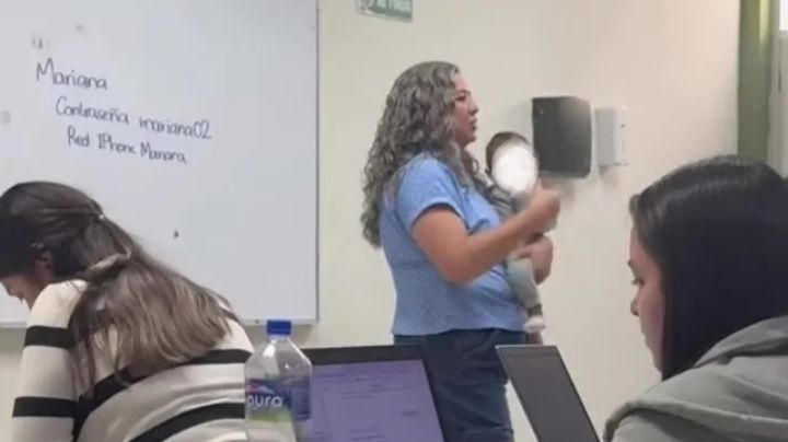 Maestra carga a bebé de su alumna para que termine sus actividades en clase | VIDEO