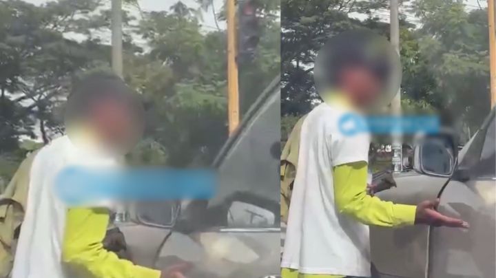 MOMENTO EXACTO en que limpiaparabrisas agrede a conductor por rechazar el servicio